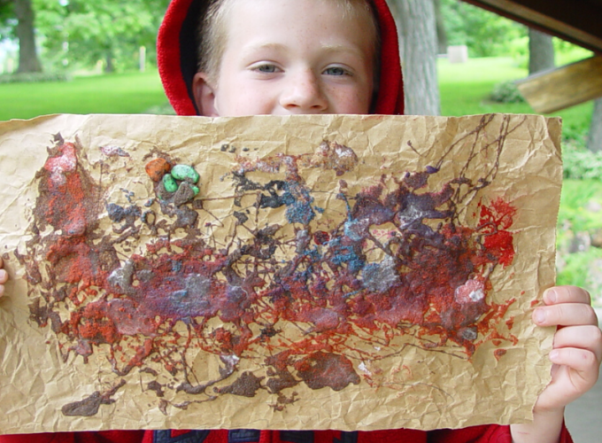 kid holding up painting crafts for kids