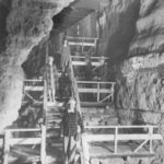 People on the old staircase in the cave circa 1940s
