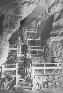 People on the old staircase in the cave circa 1940s