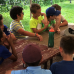 Educator talking to a group of kids before doing a Science Experiments for Kids