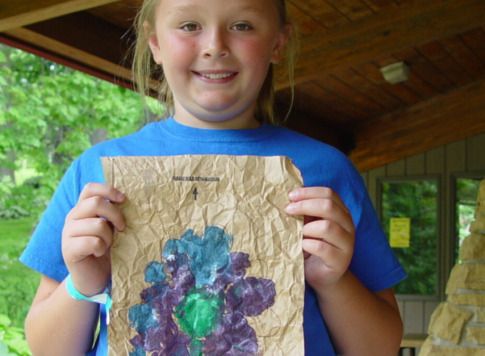 girl holding up painting crafts for kids