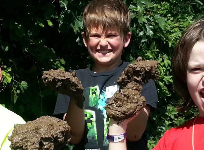 Boys holding mud for crafts for kids