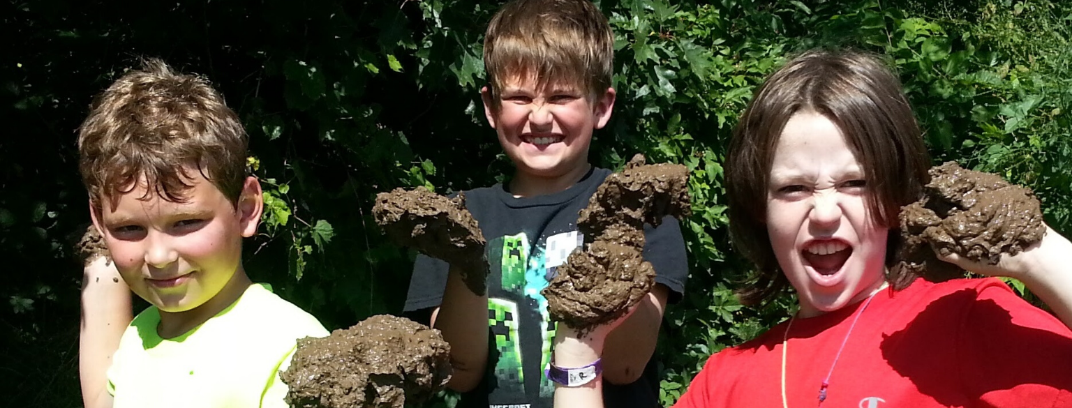 Boys holding mud for crafts for kids