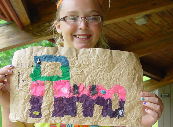 girl holding up painting crafts for kids