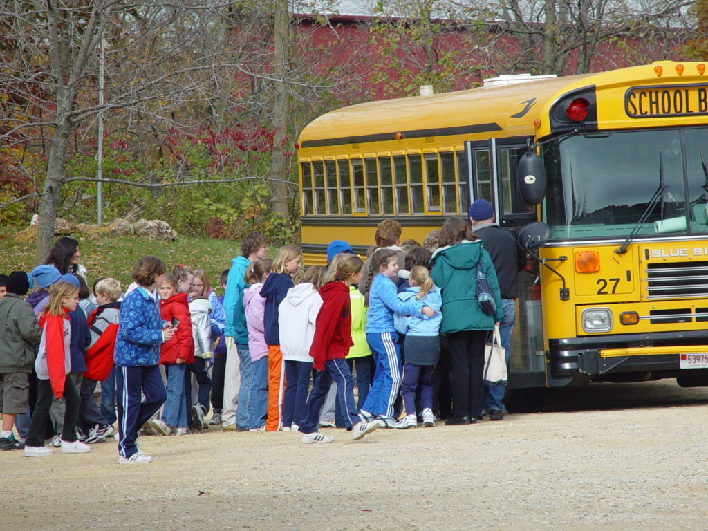 Photo of school group loading onto the bus