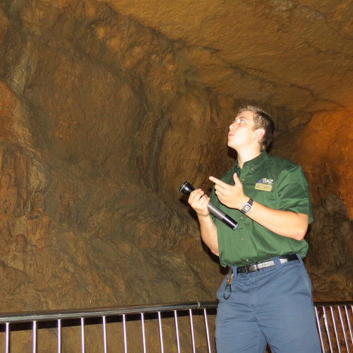 Photo of tour guide in cave which is a great Wisconsin activities