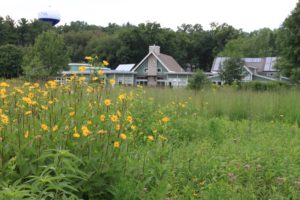 Aldo Leopold Nature Center Building seen through a row of flowers