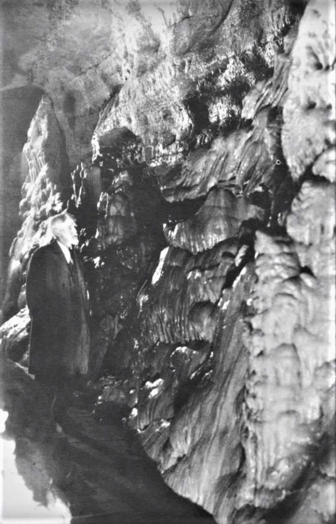 Photo of Charles I. Brigham walking in the cave.