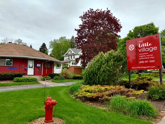 The Little Village sign and one of their buildings in red