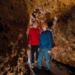 Photo of Kids in the Meanders of the cave looking around.