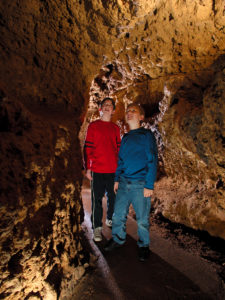 Photo of Kids in the Meanders of the cave looking around.