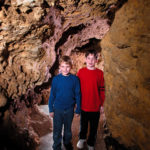 Photo of Kids in the Meanders of the cave Walking