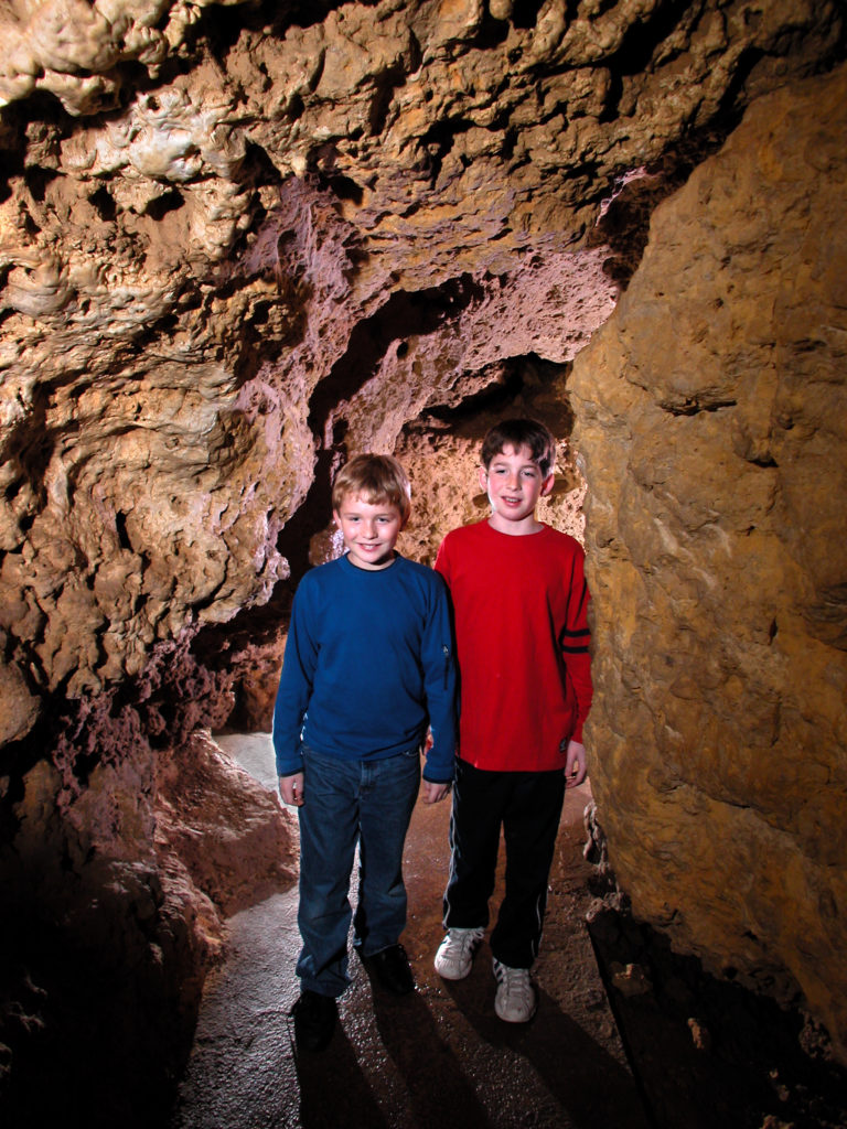 Photo of Kids in the Meanders of the cave Walking at this must-see place in Wisconsin​
