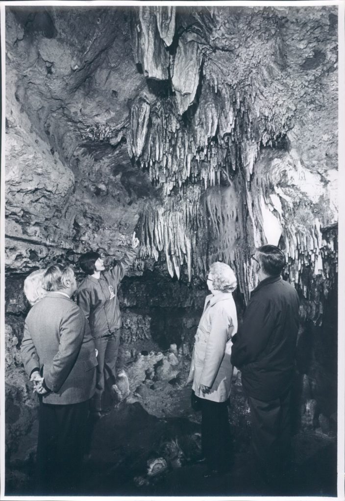 Vintage Photo of the some Guests with a Tour Guide in Cathedral Room inside the cave.