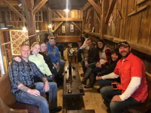 Group of friends drinking delicious Wisconsin Wine in an historic barn
