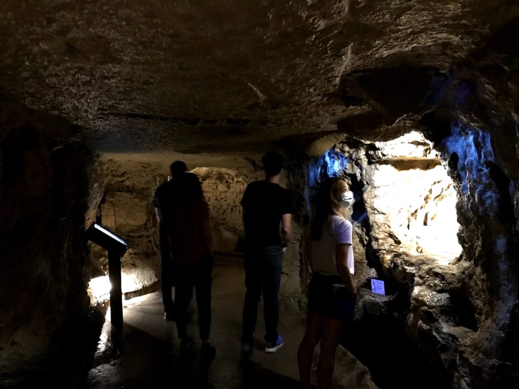 People looking at different areas of the cave