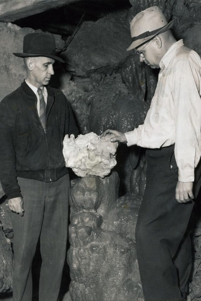 Two men looking at rocks in wisconsin history