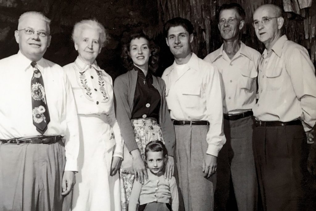 A group photo of people in commemoration of the 100000th visitor,