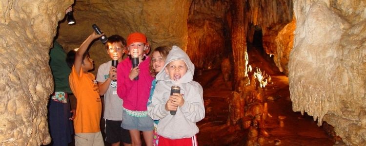 Kids in the Cave playing with flashlights
