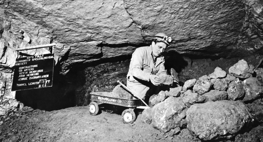 Wisocnisn Speleological Society Member studying rock from the south collapse at Cave of the Mounds