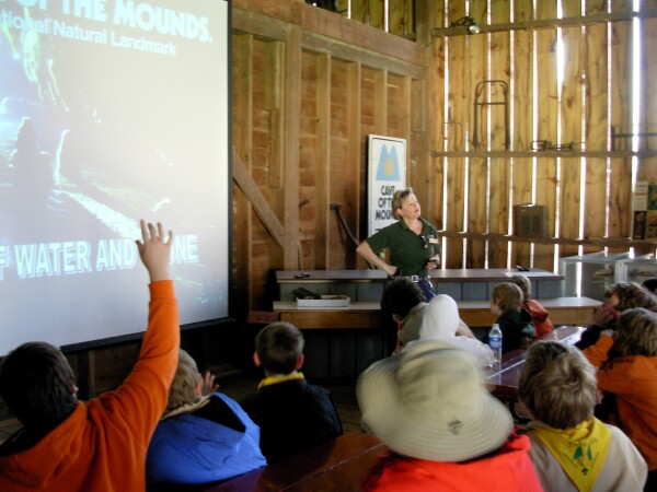 Woman teaches kids at science field trip destination Cave of the Mounds