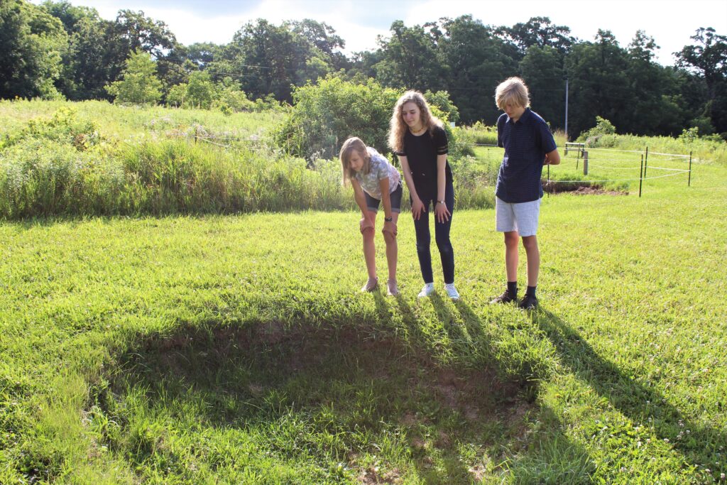 Teens look at sinkhole found at Cave of the Mounds near Green Bay