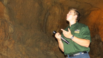 Photo of tour guide in cave which is a great Wisconsin activities