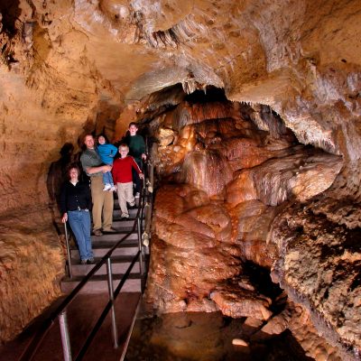 Photo of family walking in the cave. that can bee seen on a Tours in Wisconsin coolest places in Wisconsin