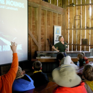 Photo of a tour guide teaching a school group