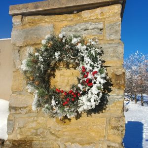 Frost covered wreath on welcome sign