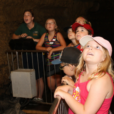 Photo of tour guide with kids in cave at a Wisconsin Destination