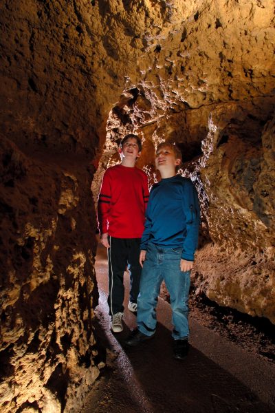 Photo of Kids in the Meanders of the cave looking around.