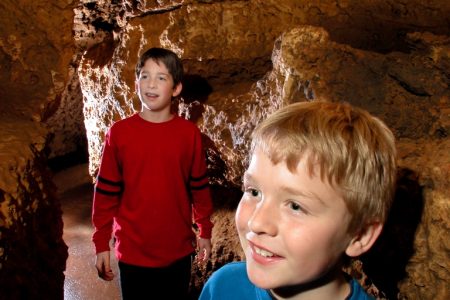 Photo of kids in the cave at this Must See Destination in Wisconsin and one of the best Wisconsin activities