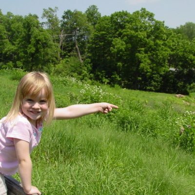 Photo of a girl pointing at the wonders along our nature trails. one of the many Fun Things to do while visiting places in Wisconsin