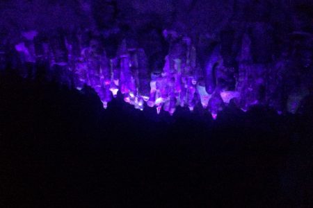 Photo of stalactites under a blacklight at this Must See Destination in Wisconsin showing Photoluminescence