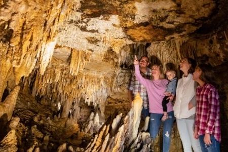 Family observing formation speleothem in Cave of the Mounds a place to visit in wisconsin