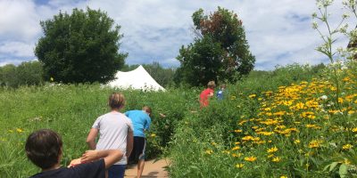 Kids walking through a prairie garden as one of the Wisconsin activities we offer