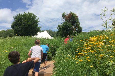 Kids walking through a prairie garden as one of the Wisconsin activities we offer