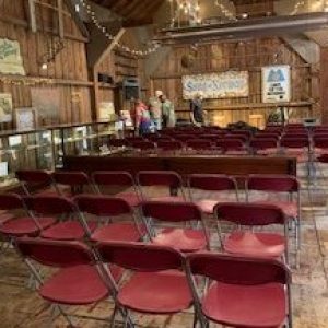 Chairs lined up for band performance in rustic barn