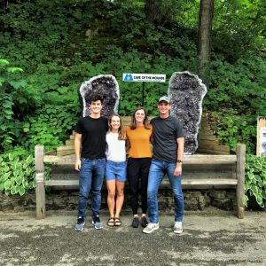 Group of four people in front of an amethyst cathedral at a midwest cave