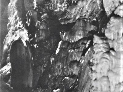 Photo of Charles I. Brigham walking in the cave.