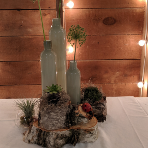 Centerpiece for an event with wine bottles and flowers unique place to visit in Wisconsin